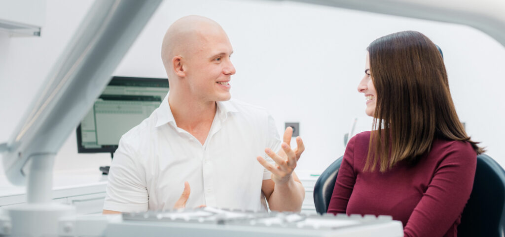 Zahnarzt Dr. Nowak berät Patienten in Berlin.